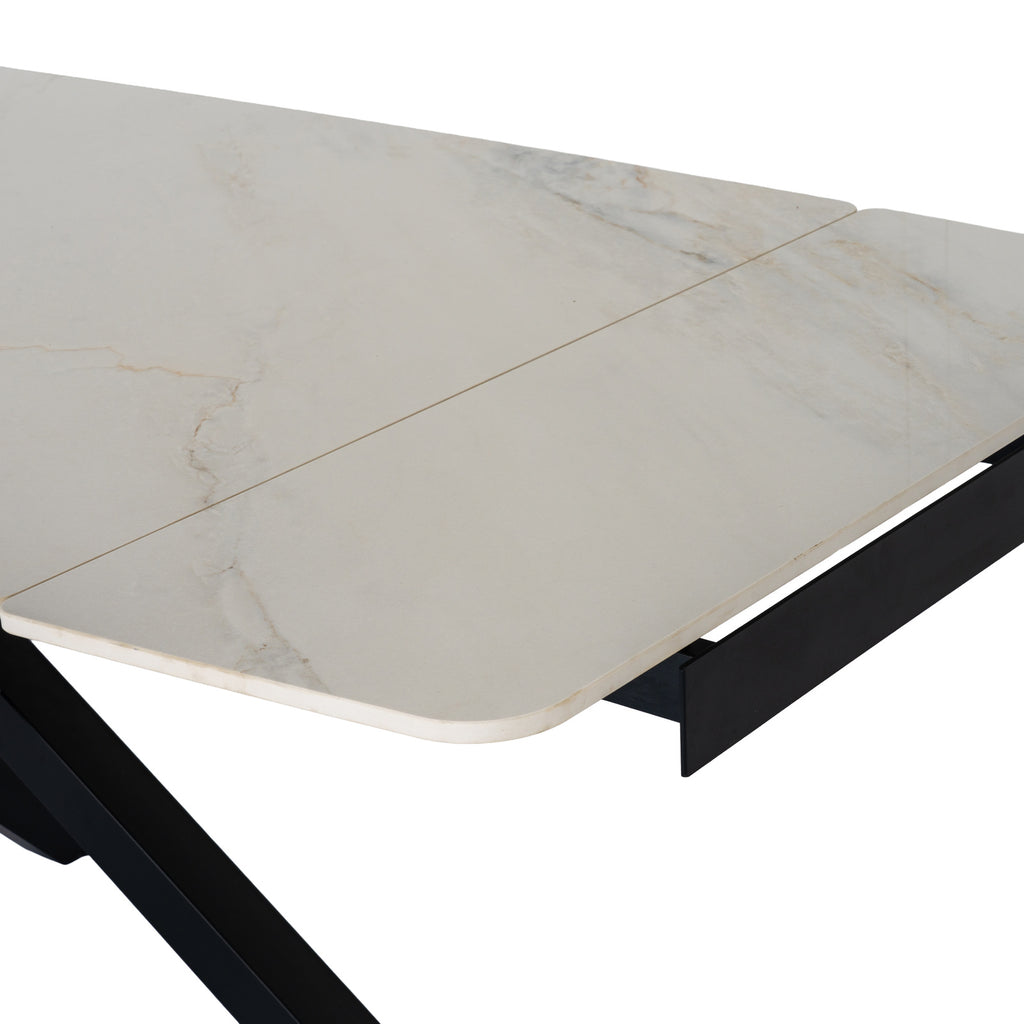 Romanby Stone extending dining table by Hill Interiors, showcasing a modern, stone-top design with extended surface and sturdy legs.
