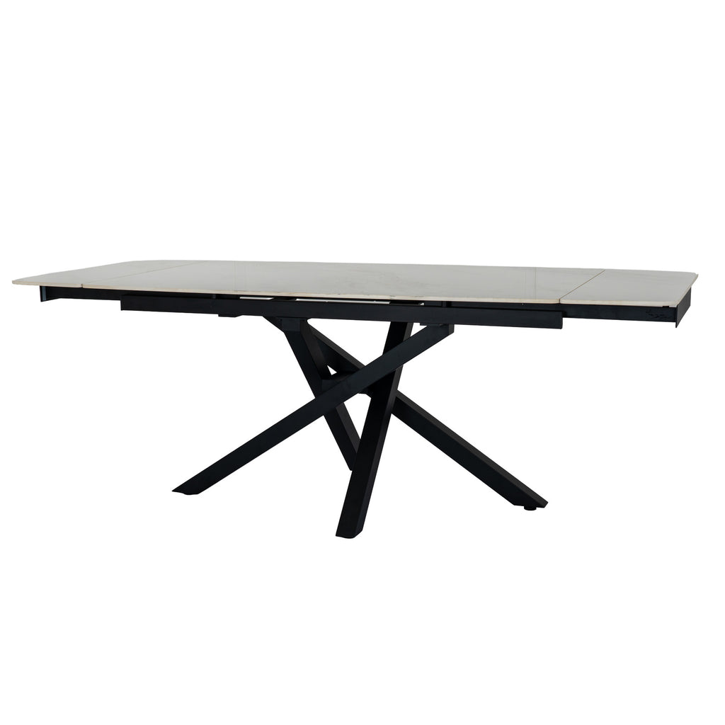 Romanby Stone extending dining table by Hill Interiors, showing the elegant stone surface and extendable design in a modern dining room setting.