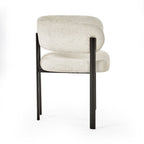 Set of two Julian Bowen Bolivia dining chairs with sleek modern design and wooden legs, shown from a side angle.