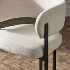 Pair of Julian Bowen Bolivia dining chairs with sleek wooden design and cushioned seats, set against a neutral background.