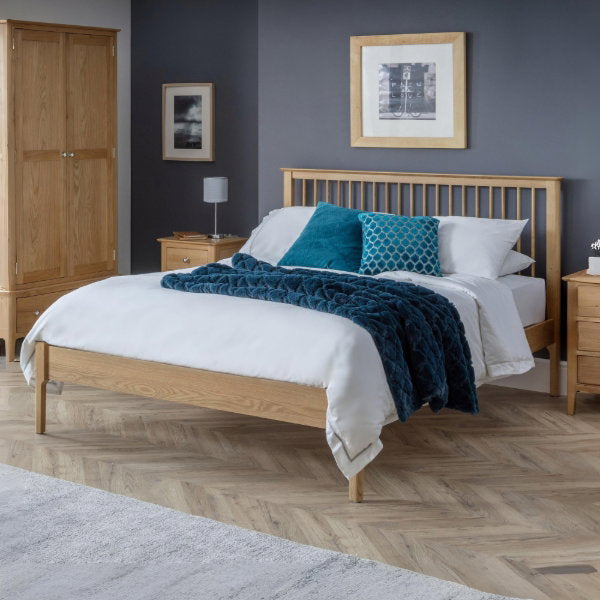Julian Bowen Cotswold Bed with wooden frame and classic design, shown in a bedroom setting with bedding and pillows.
