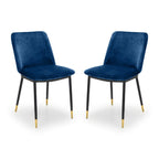 Pair of Julian Bowen Delaunay dining chairs with sleek wooden frames and cushioned seats, set against a neutral background.