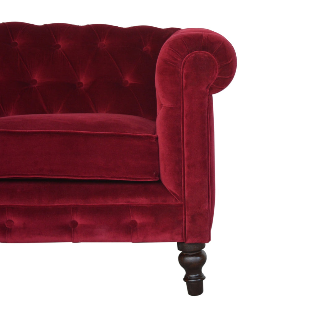 Artisan velvet Chesterfield sofa with deep button tufting and rolled arms, showcasing luxurious fabric and elegant design.