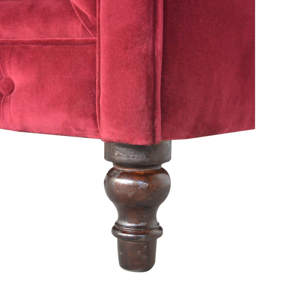 Artisan velvet Chesterfield sofa with tufted design and rolled arms, showcasing luxurious upholstery and classic elegance.
