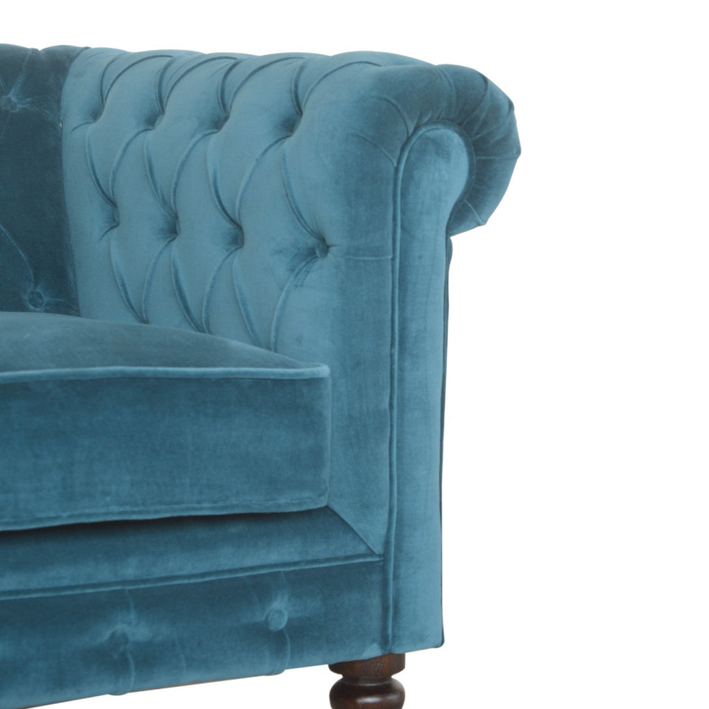 Artisan velvet Chesterfield sofa with tufted back and rolled arms, showcasing luxurious fabric and elegant design.
