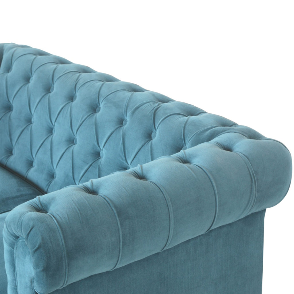 Artisan velvet Chesterfield sofa with tufted upholstery and rolled arms, shown in a luxurious deep color.
