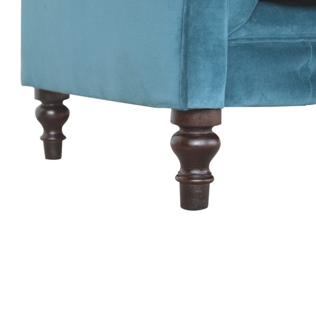 Artisan velvet Chesterfield sofa with deep button tufting and rolled arms, showcasing luxurious upholstery and classic design.