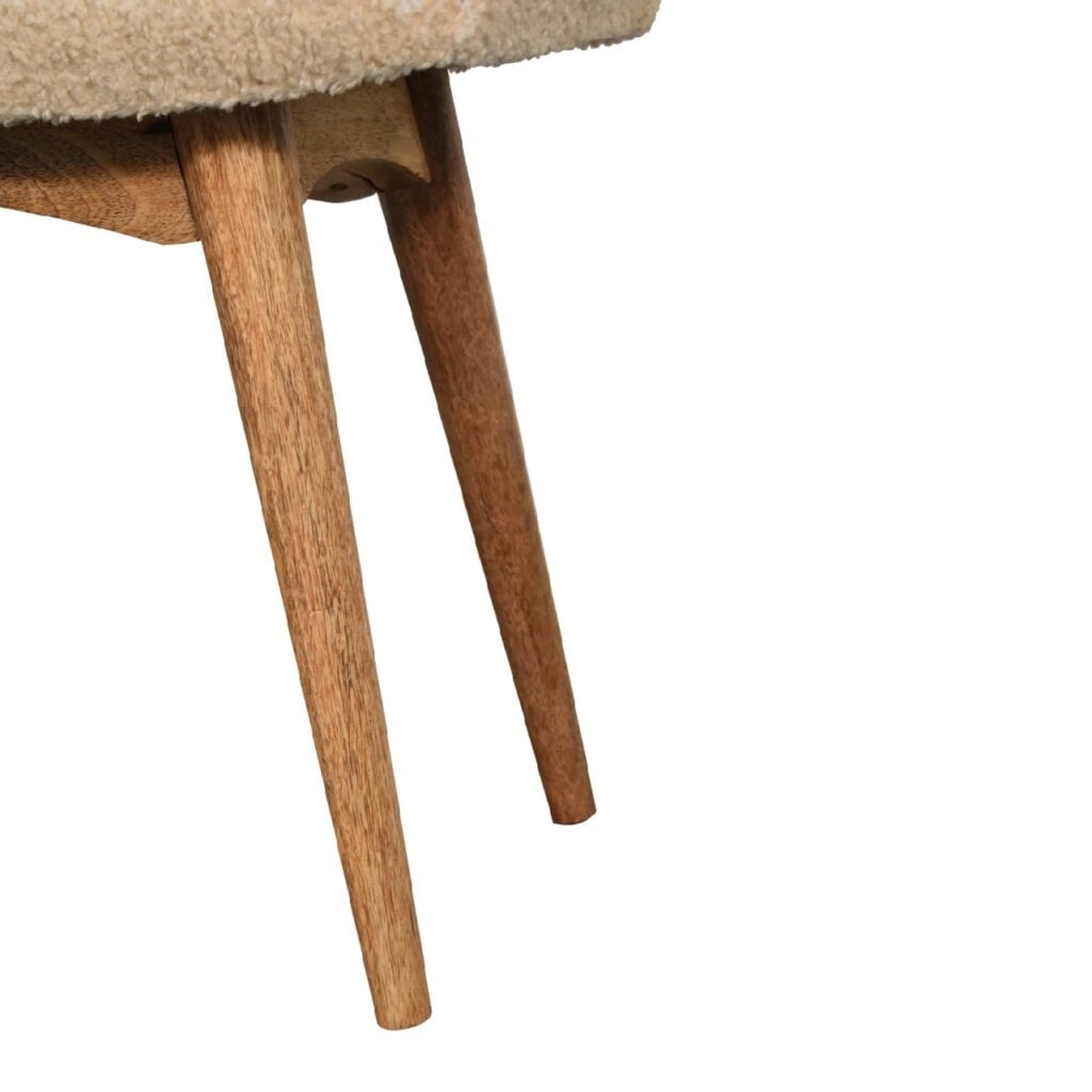 Artisan boucle cream curved bench stool with plush upholstery and wooden legs, ideal for modern living spaces.
