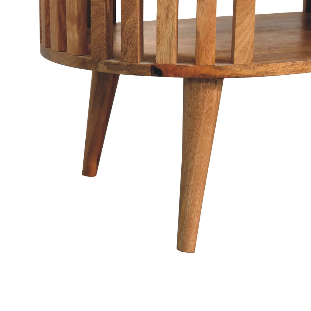 Artisan Ariella coffee table with a sleek wooden surface and modern design, shown from a side angle.