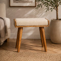 Artisan boucle cream tray style footstool with a plush upholstered seat and wooden legs, showcasing elegant and comfortable design.