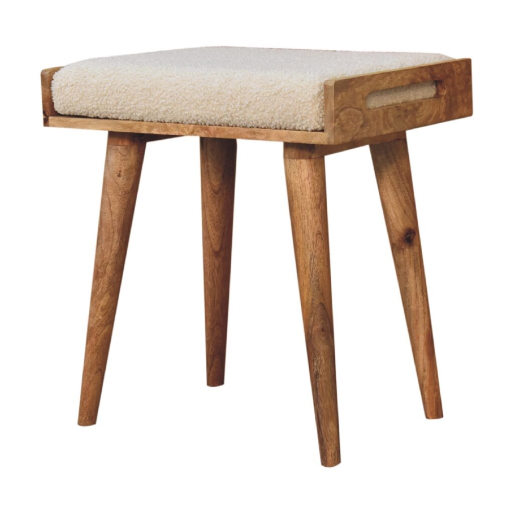 Artisan boucle cream tray-style footstool with round shape and soft fabric upholstery, perfect for living room or lounge decor.