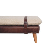 Close-up detail of the mahogany leather harness strap wrapping around the bouclé seat.