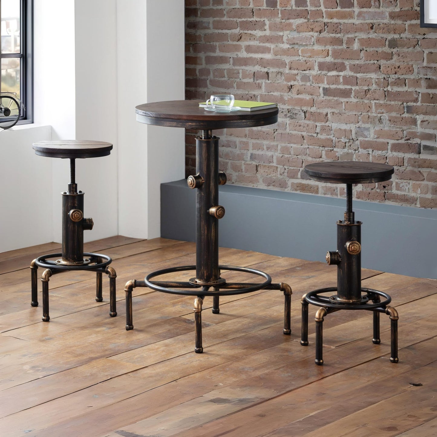 Rockport industrial pipework bar table and two matching stools set styled against an exposed brick wall on a dark wood floor