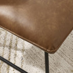 Julian Bowen Saxon Lounge Chair in fabric with curved armrests and wooden legs, designed as a stylish accent chair.