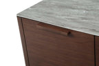 Close-up of a Willow  sideboard cabinet corner with a gray stone-look countertop and dark brown wood grain drawer front, featuring  rectangular handle.