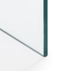 Close-up shot showing the base edge of the transparent Amalfi glass desk resting on the floor