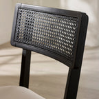 Close-up view of the black woven rattan cane backrest detail on the Annika dining chair