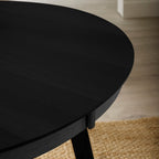 Detail shot of the sleek black wood grain finish on the Annika dining table surface