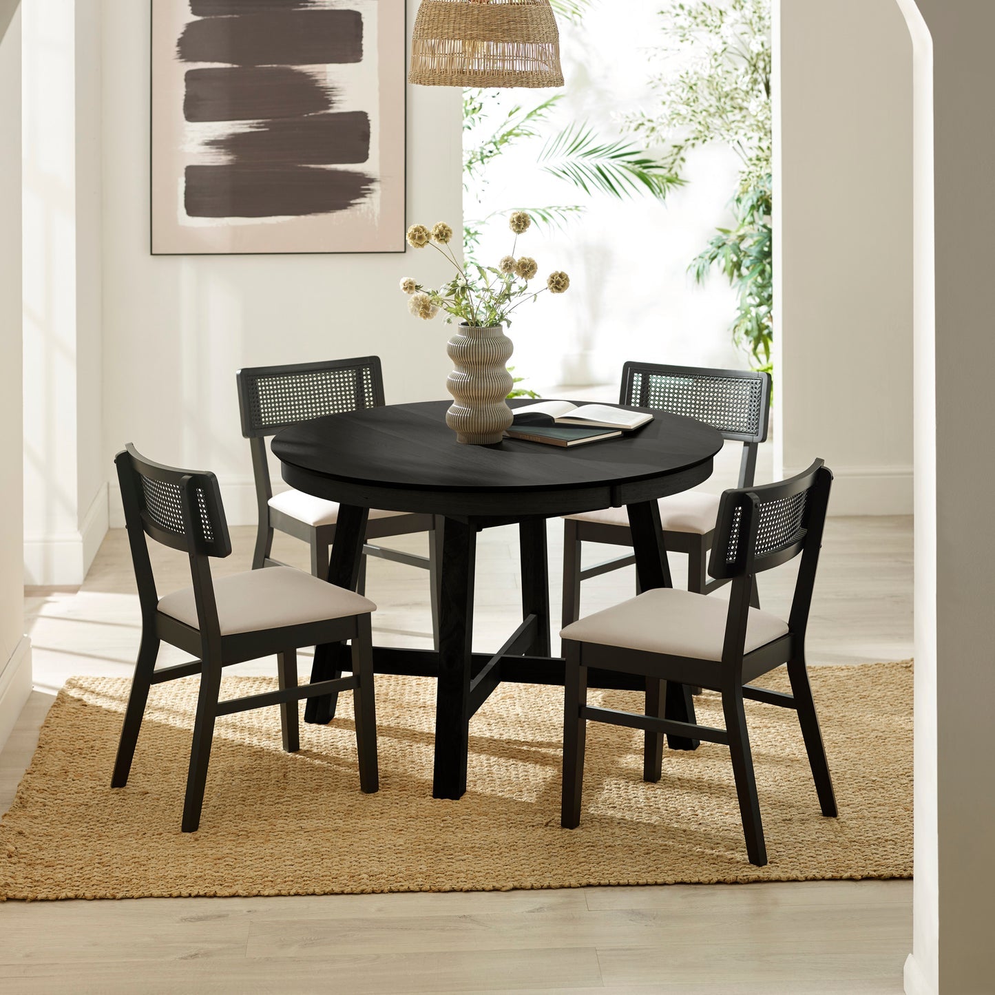 Annika black extending dining table styled with matching Annika rattan back dining chairs