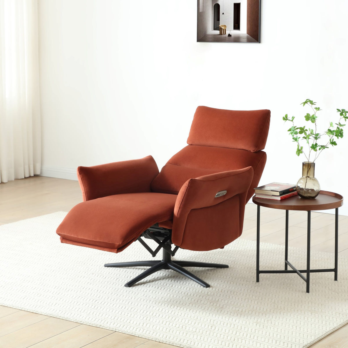 Burnt orange Austin electric recliner armchair placed beside a side table in a bright lounge area   