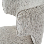 Close-up detail of the mist-grey woven fabric on the curved barstool backrest.