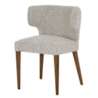 Side perspective view showing the curved silhouette and warm wood legs of the Avia Mist grey dining chair