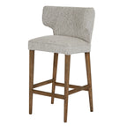 Three-quarter perspective view of the Avia Mist Barstool with light wood legs.