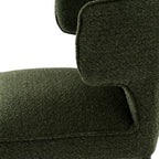 Close-up detail of the rich moss-green upholstery texture on the curved barstool backrest.