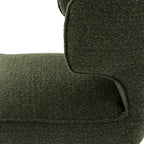 Close-up view of the wrap-around backrest arm and dark frame on the Avia Moss green dining chair