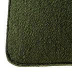 Detailed shot highlighting the rich textured weave of the Moss green fabric on the Avia dining chair