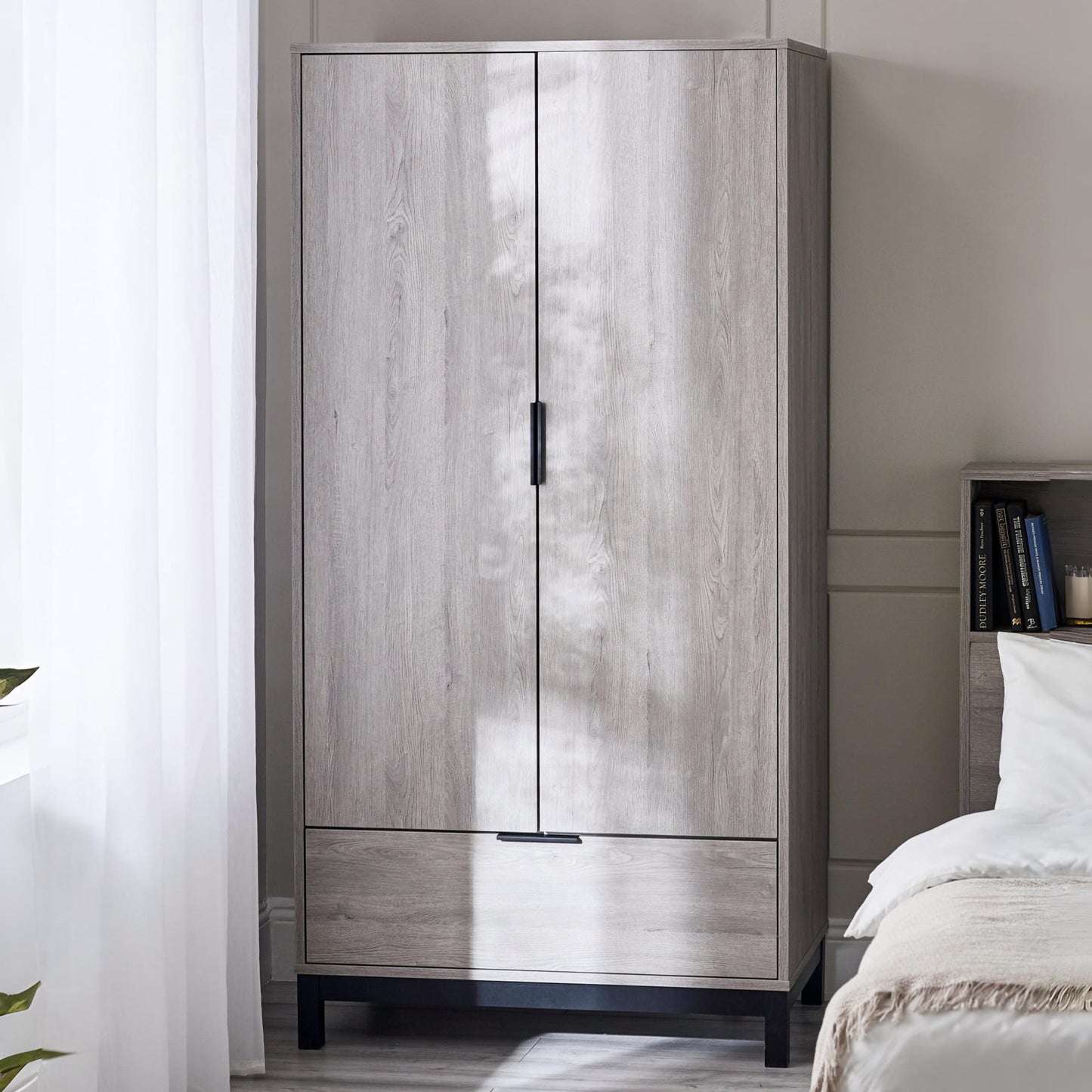 Bali grey oak effect 2 door 1 drawer wardrobe styled in a bright minimalist bedroom setup