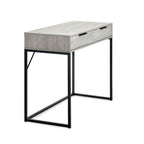 Side perspective view displaying the slim depth profile and black metal box-frame base of the Bali grey desk