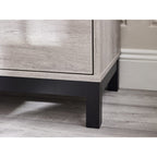 Detail shot showing the black metal frame leg and lower border on the Bali grey oak chest
