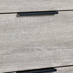 Detail shot of the grey oak drawer front and black lip pull handle on the Bali 4 drawer chest