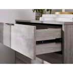 Close-up view of an open drawer displaying the internal depth and metal drawer runner on the Bali grey chest