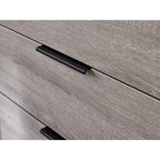 Close-up view of the grey oak wood effect texture and slim black metal lip drawer handle on the Bali chest