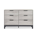 Front elevation view of the Bali grey oak 6 drawer wide chest showing the black handles and metal base