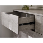 Detail shot of an open drawer highlighting the metal runner mechanism and internal storage depth on the Bali grey chest