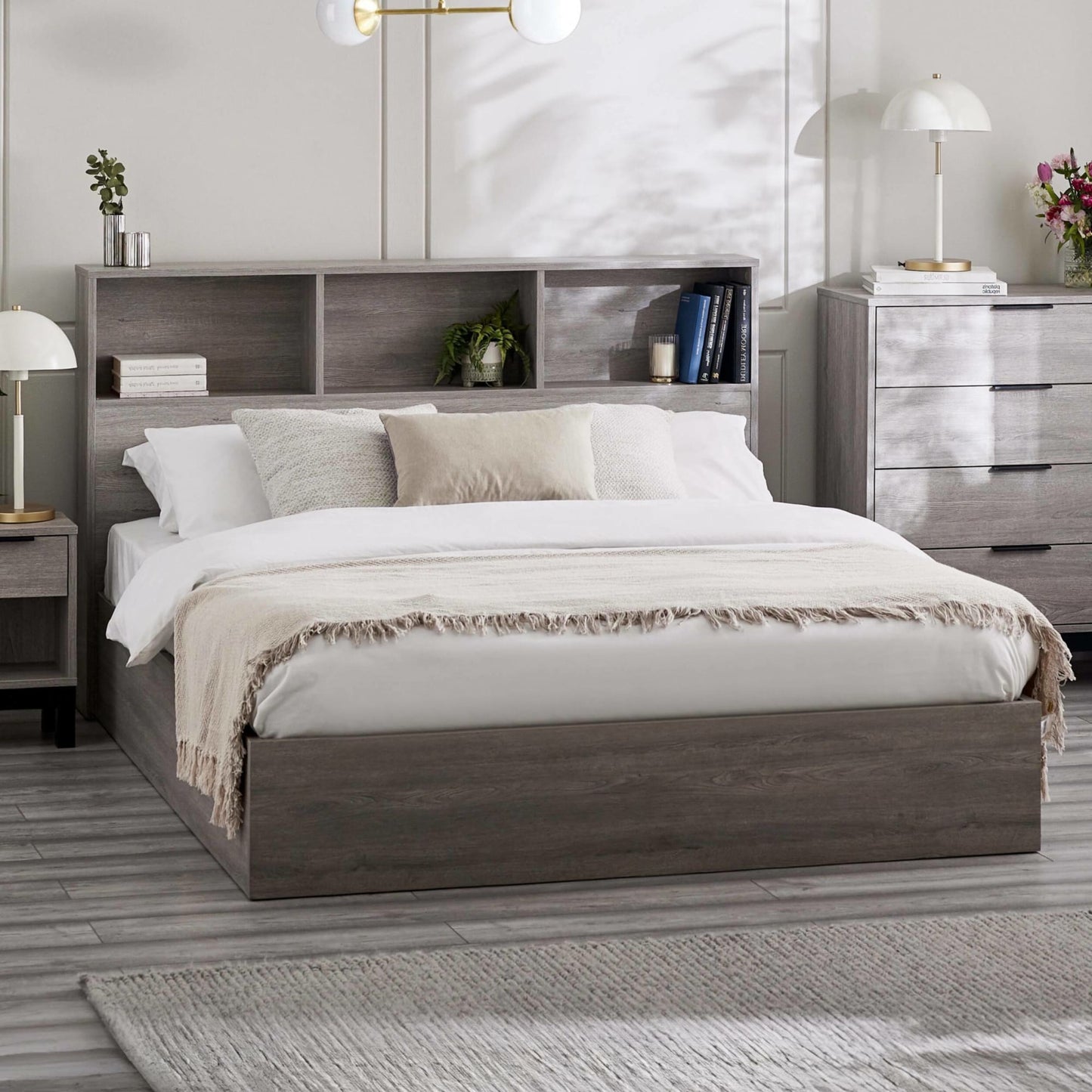 Grey oak Bali ottoman bed with integrated bookcase headboard in a bedroom setting