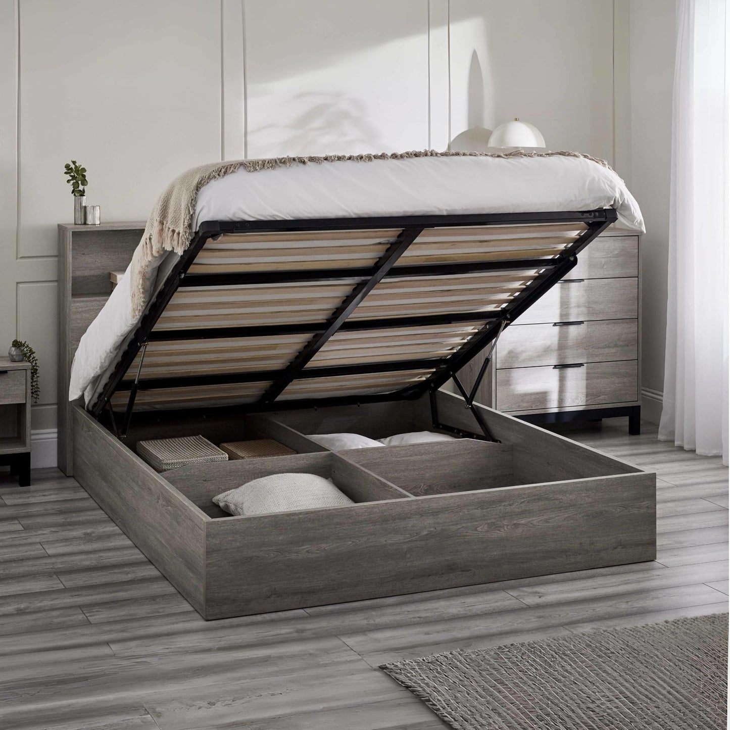 Bali grey oak ottoman bed frame raised open demonstrating hydraulic lift storage