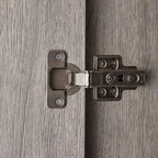 Detail shot showing the black metal frame legs and lower edge of the Bali grey oak wardrobe