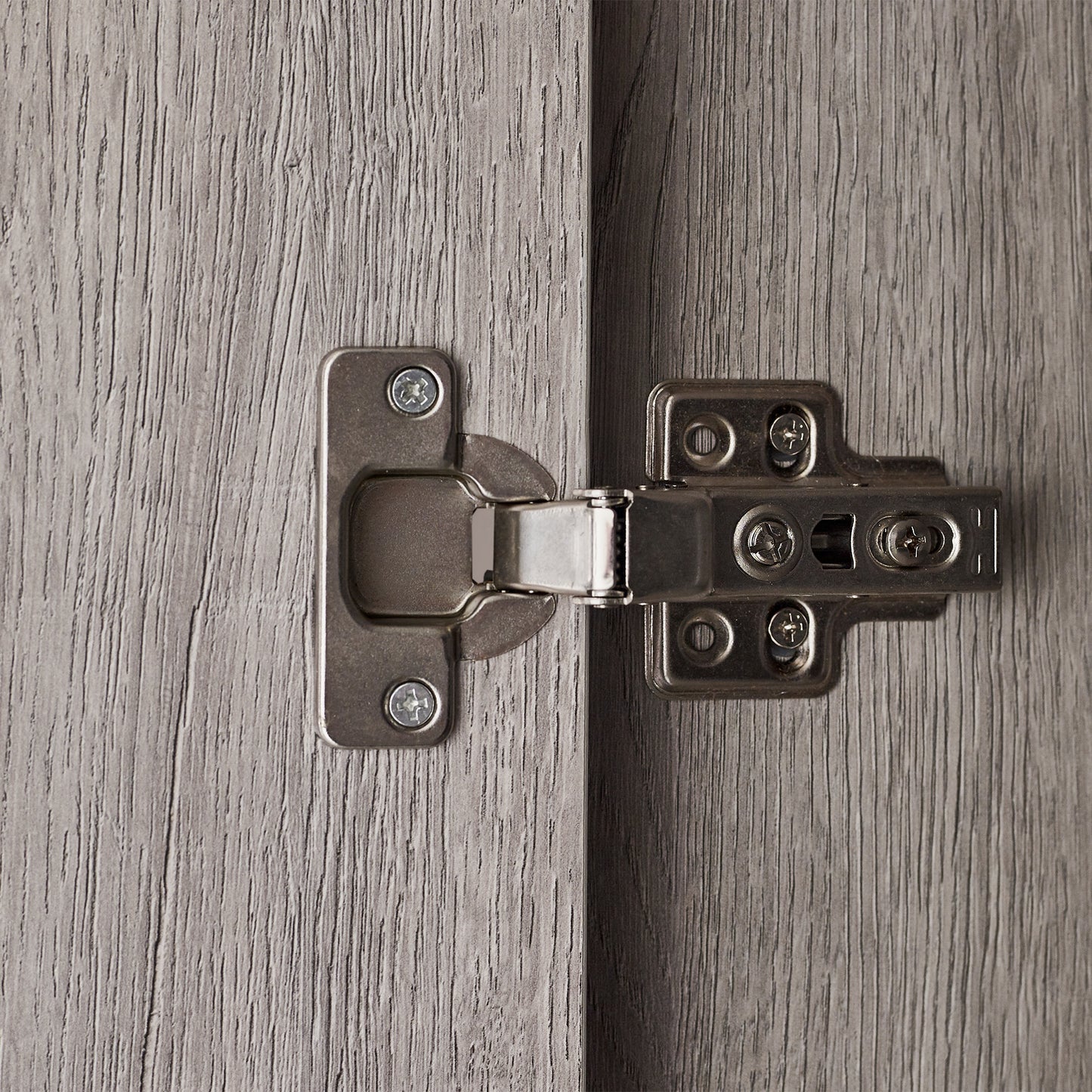 Detail shot showing the black metal frame legs and lower edge of the Bali grey oak wardrobe