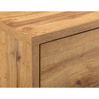 Detail view of the natural oak wood effect finish and clean top corner profile of the Bali bedside table