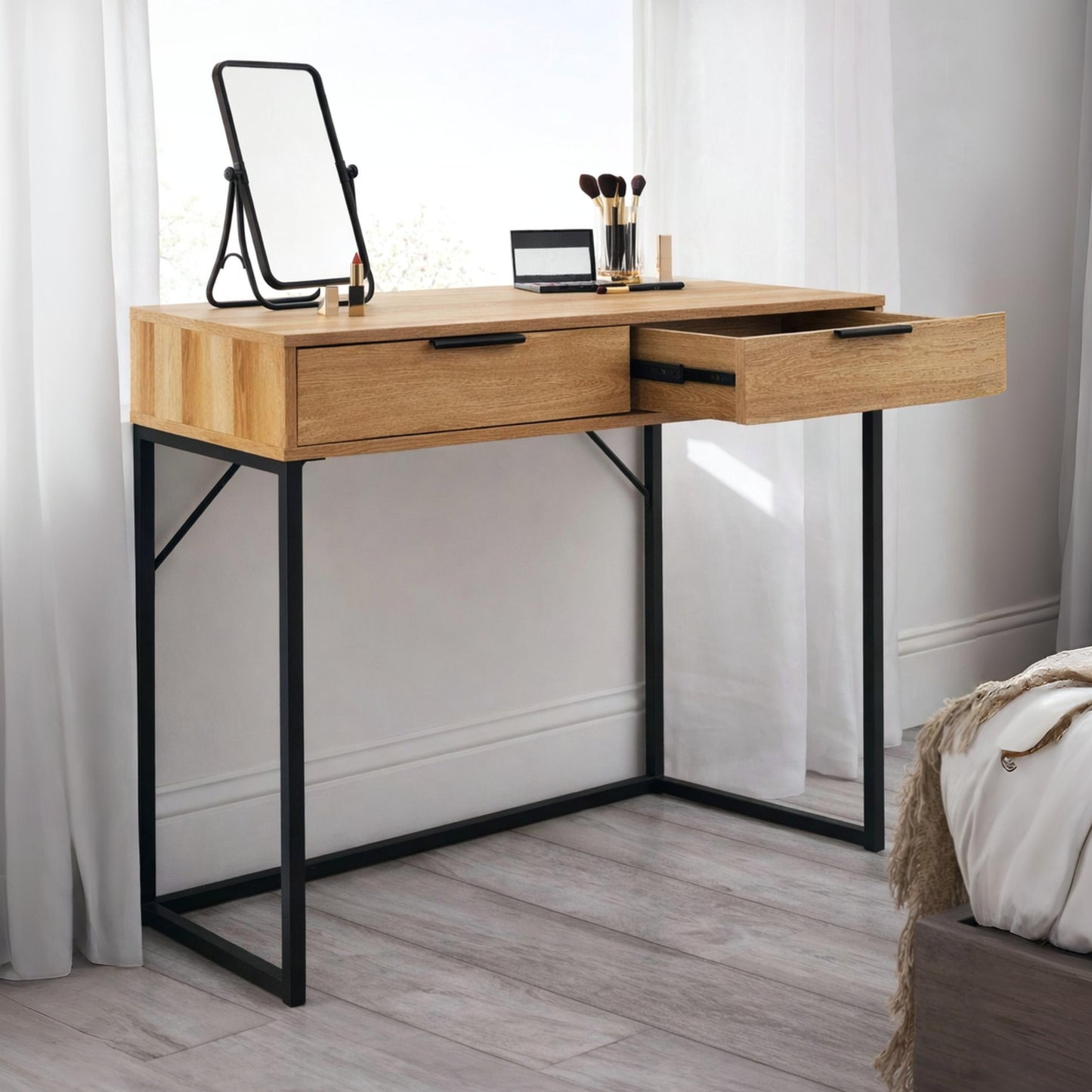 Bali natural oak effect 2 drawer dressing table desk styled with a table mirror and makeup brushes in a bright bedroom