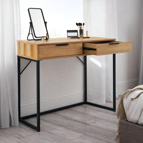 Bali natural oak effect 2 drawer dressing table desk styled with a table mirror and makeup brushes in a bright bedroom
