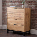 Bali natural oak effect 4 drawer chest styled against a brick wall in an industrial bedroom with a potted plant on top
