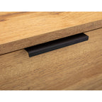 Close-up shot showing the natural oak wood effect texture and slim black metal lip drawer handle on the Bali chest