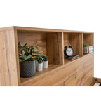 Close-up of integrated storage headboard shelves with books and small plants in natural oak finish