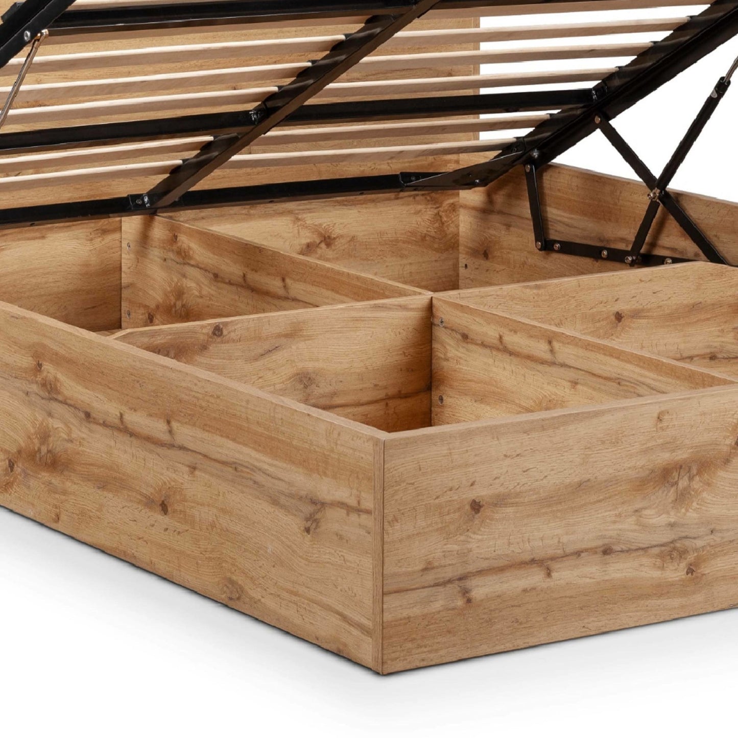 Close-up of spacious underbed storage compartment base in natural oak finish
