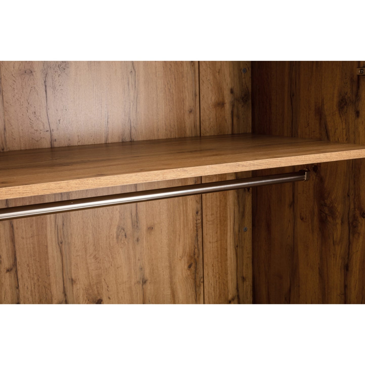 Close-up view of the interior top shelf and metal hanging rail inside the Bali oak effect wardrobe